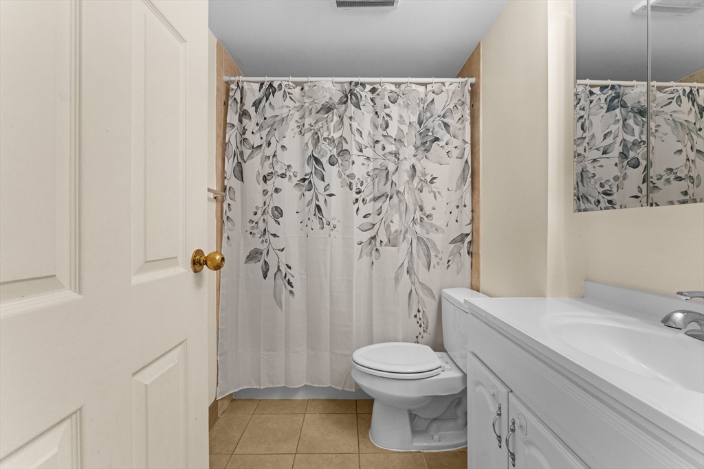 135 Pleasant Street, Unit 106 Brookline, MA 02446 - Photo 23 of 27 a bathroom with a toilet sink and shower