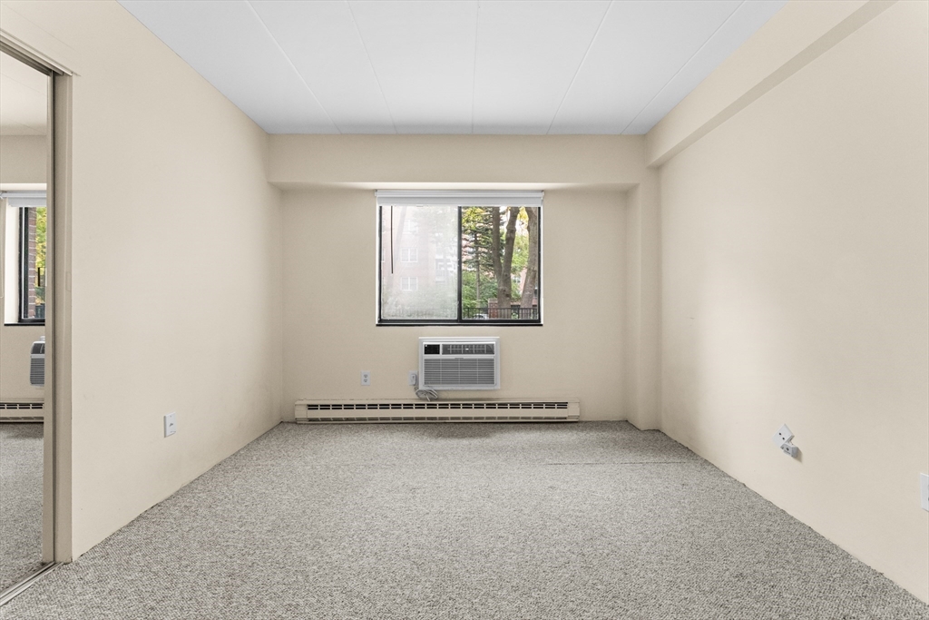 135 Pleasant Street, Unit 106 Brookline, MA 02446 - Photo 27 of 27 an empty room with windows