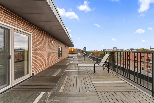 a balcony with wooden floor and furniture