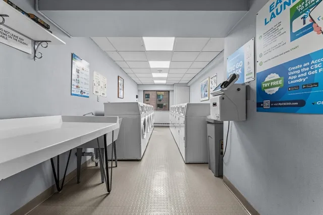 a view of a kitchen center island and stainless steel appliances