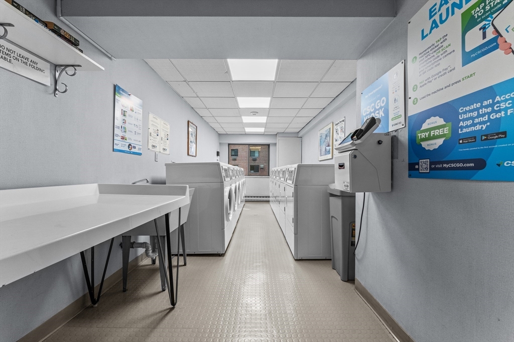 135 Pleasant Street, Unit 106 Brookline, MA 02446 - Photo 10 of 27 a view of a kitchen center island and stainless steel appliances