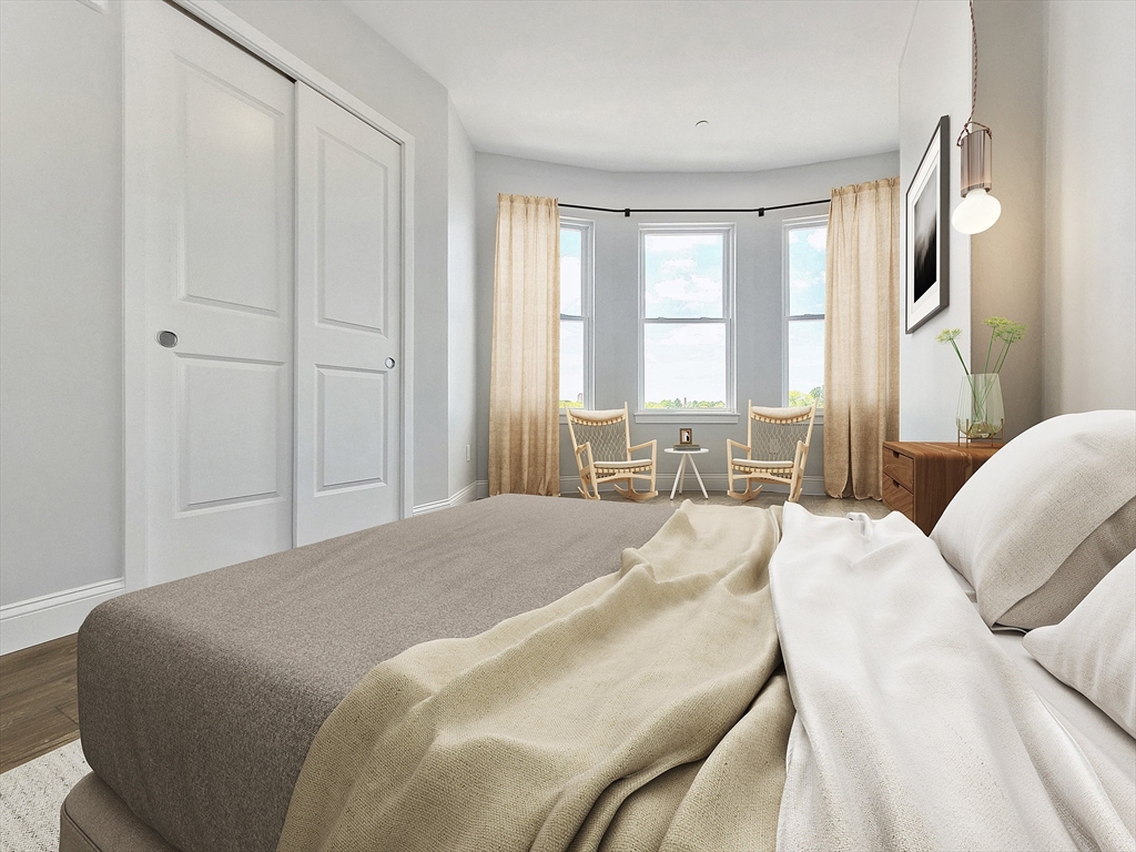 334-336 Warren Street, Unit 3 Boston, MA 02119 - Photo 3 of 10 a spacious bedroom with a bed and glass cabinets
