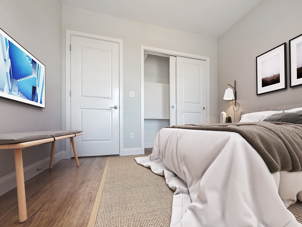 334-336 Warren Street, Unit 3 Boston, MA 02119 - Photo 7 of 10 a spacious bedroom with a bed and a desk
