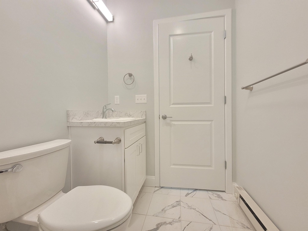 334-336 Warren Street, Unit 3 Boston, MA 02119 - Photo 8 of 10 a bathroom with a sink a toilet and shower