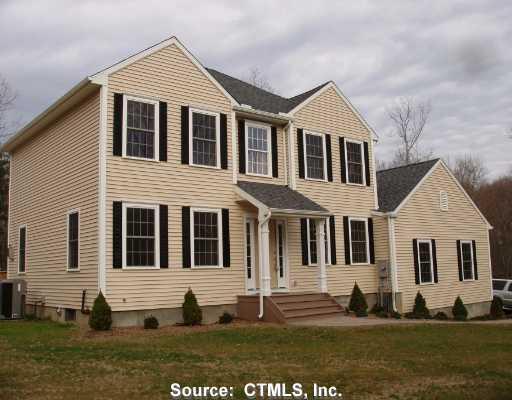 58 Burrows Hill Road Hebron, CT 06231 - Photo 1 of 1 a view of a white house with large windows and a yard