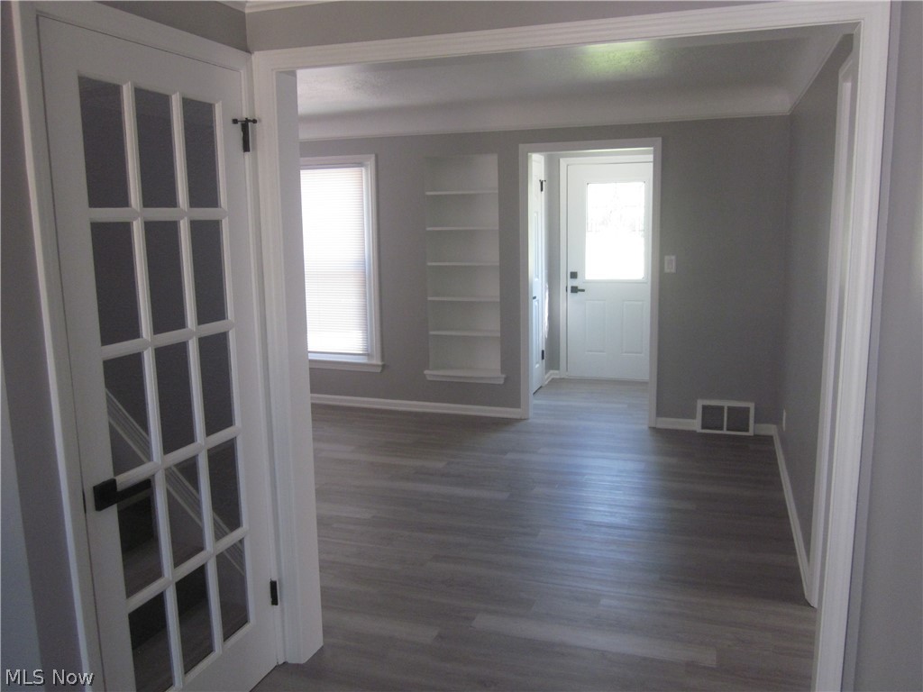 1810 Lorimer Road Cleveland, OH 44134 - Photo 14 of 47 Spare room featuring built in features and dark hardwood / wood-style flooring