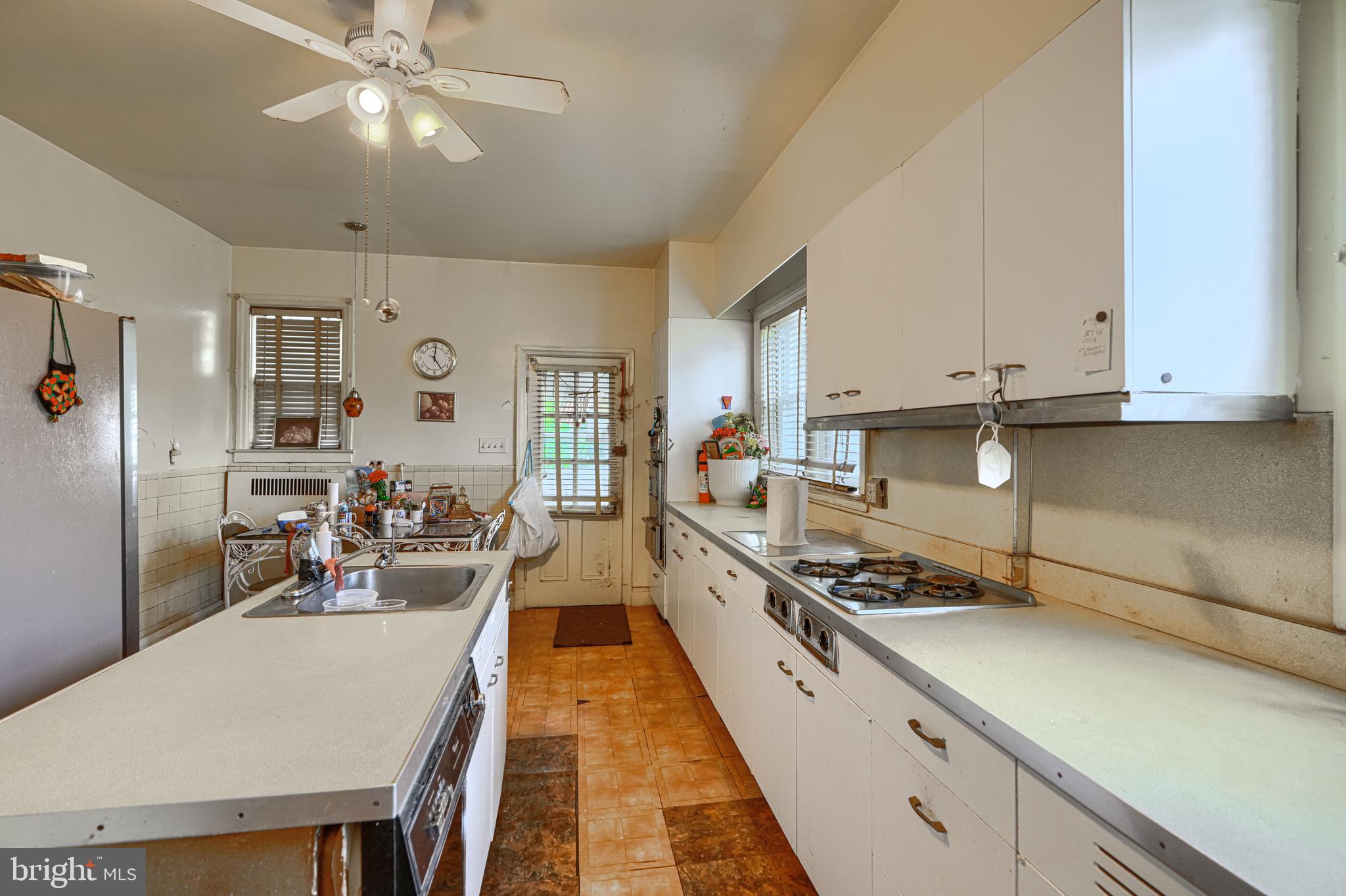 3212 Dorchester Road Baltimore, MD 21215 - Photo 17 of 45 a large kitchen with stainless steel appliances granite countertop a lot of counter space a sink and cabinets