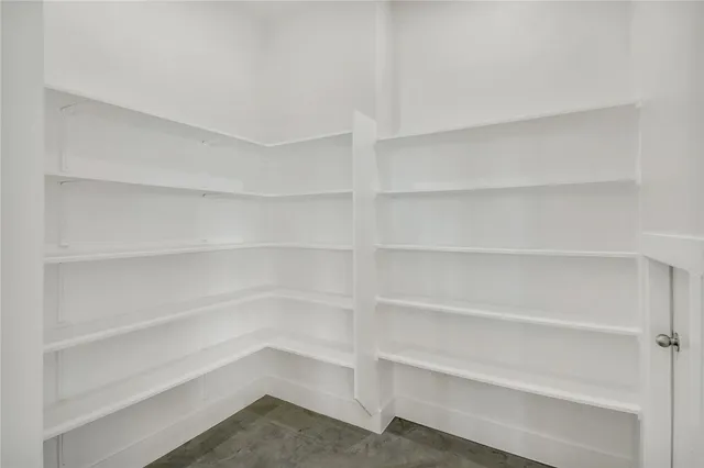 a view of walk in closet with empty racks