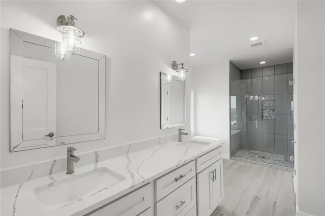 a bathroom with a sink double vanity and shower