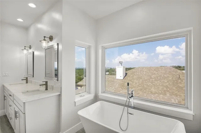 a bathroom with a sink a vanity and a large mirror