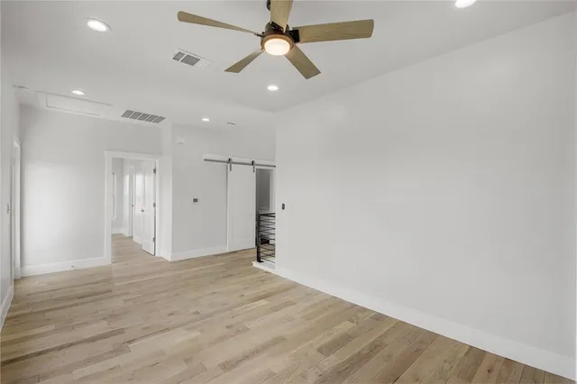 an empty room with fan and a ceiling fan