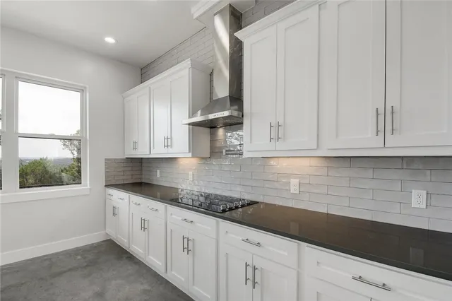 a kitchen with granite countertop white cabinets white appliances a sink and dishwasher