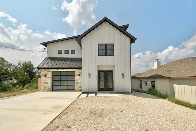 a front view of a house with a yard and garage
