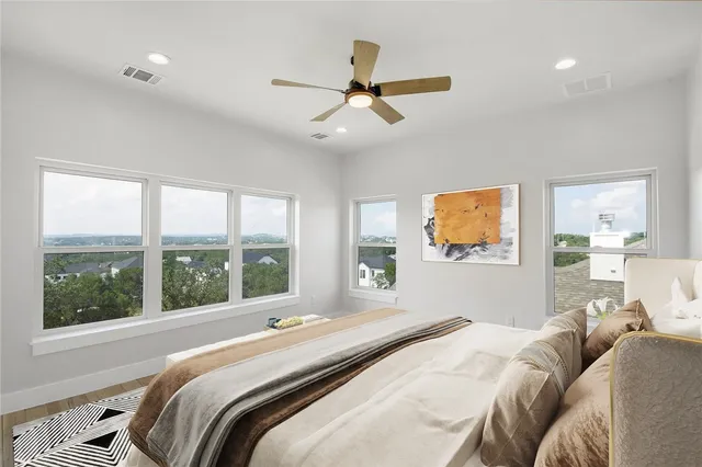 a bedroom with a bed and a large window