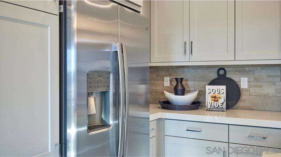 2021 Bluestone Circle, Unit HS71 PLAN Chula Vista, CA 91913 - Photo 5 of 12 a kitchen with a refrigerator and cabinets