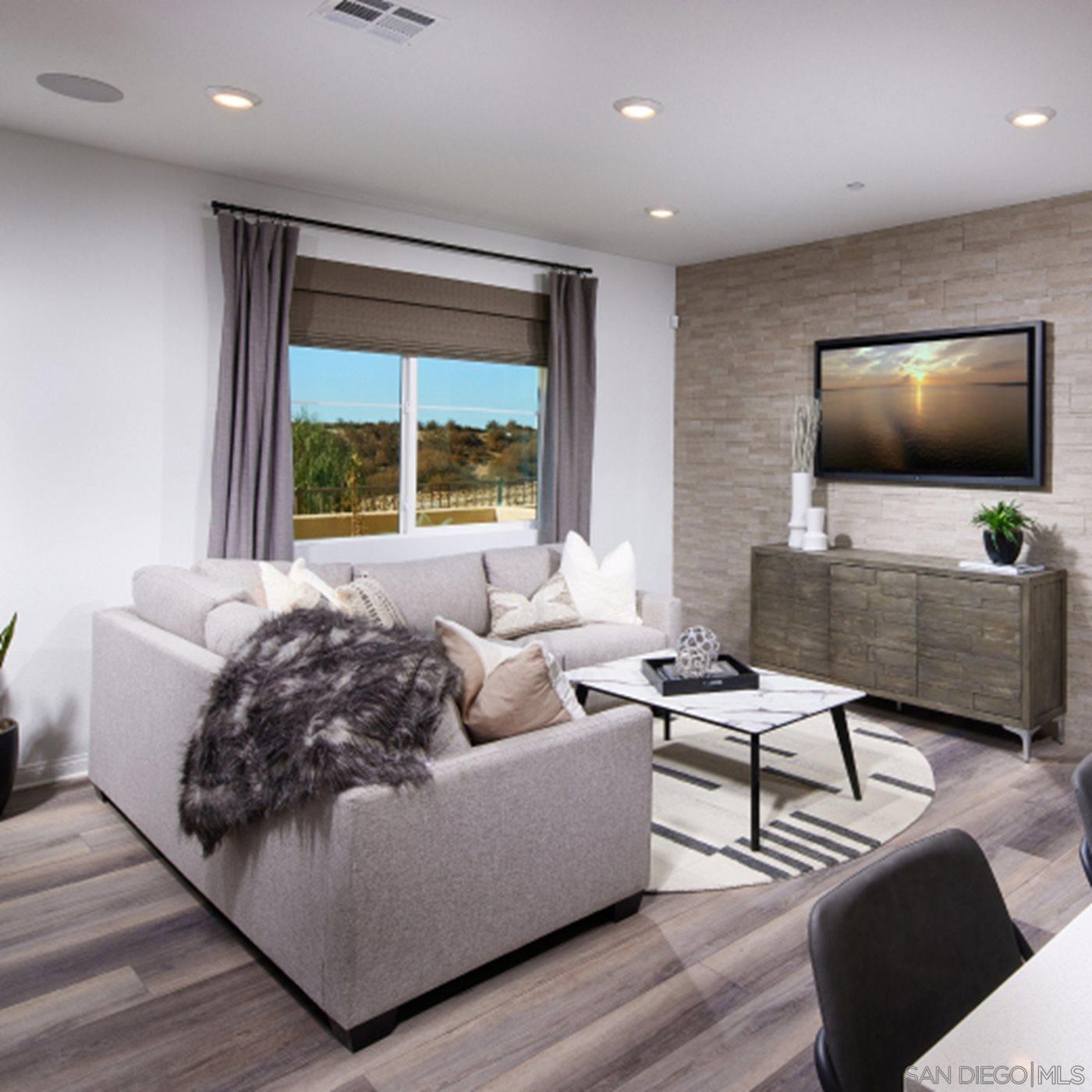 2021 Bluestone Circle, Unit HS71 PLAN Chula Vista, CA 91913 - Photo 7 of 12 a living room with furniture and a flat screen tv