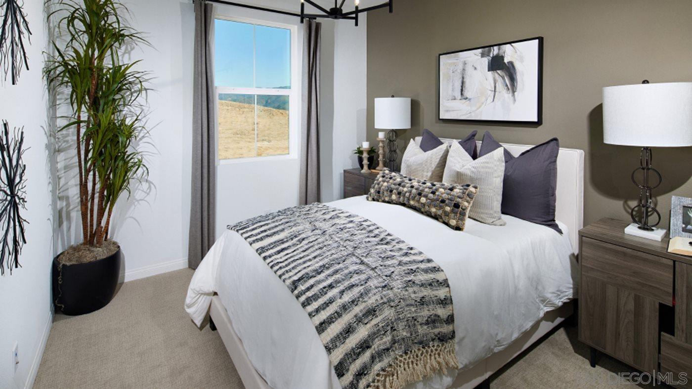 2021 Bluestone Circle, Unit HS71 PLAN Chula Vista, CA 91913 - Photo 8 of 12 a bedroom with a bed and a potted plant