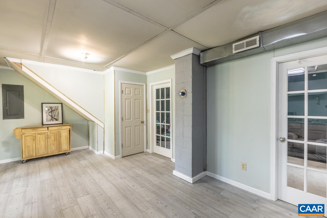 4764 Amicus Road Ruckersville, VA 22968 - Photo 2 of 33 a view of an empty room with wooden floor and windows