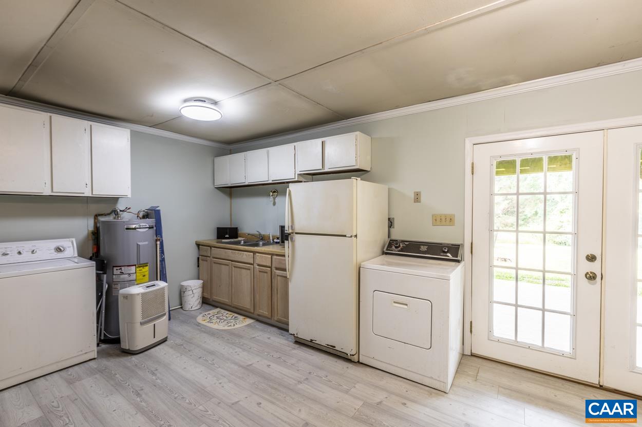 4764 Amicus Road Ruckersville, VA 22968 - Photo 30 of 33 a kitchen with a stove sink and refrigerator