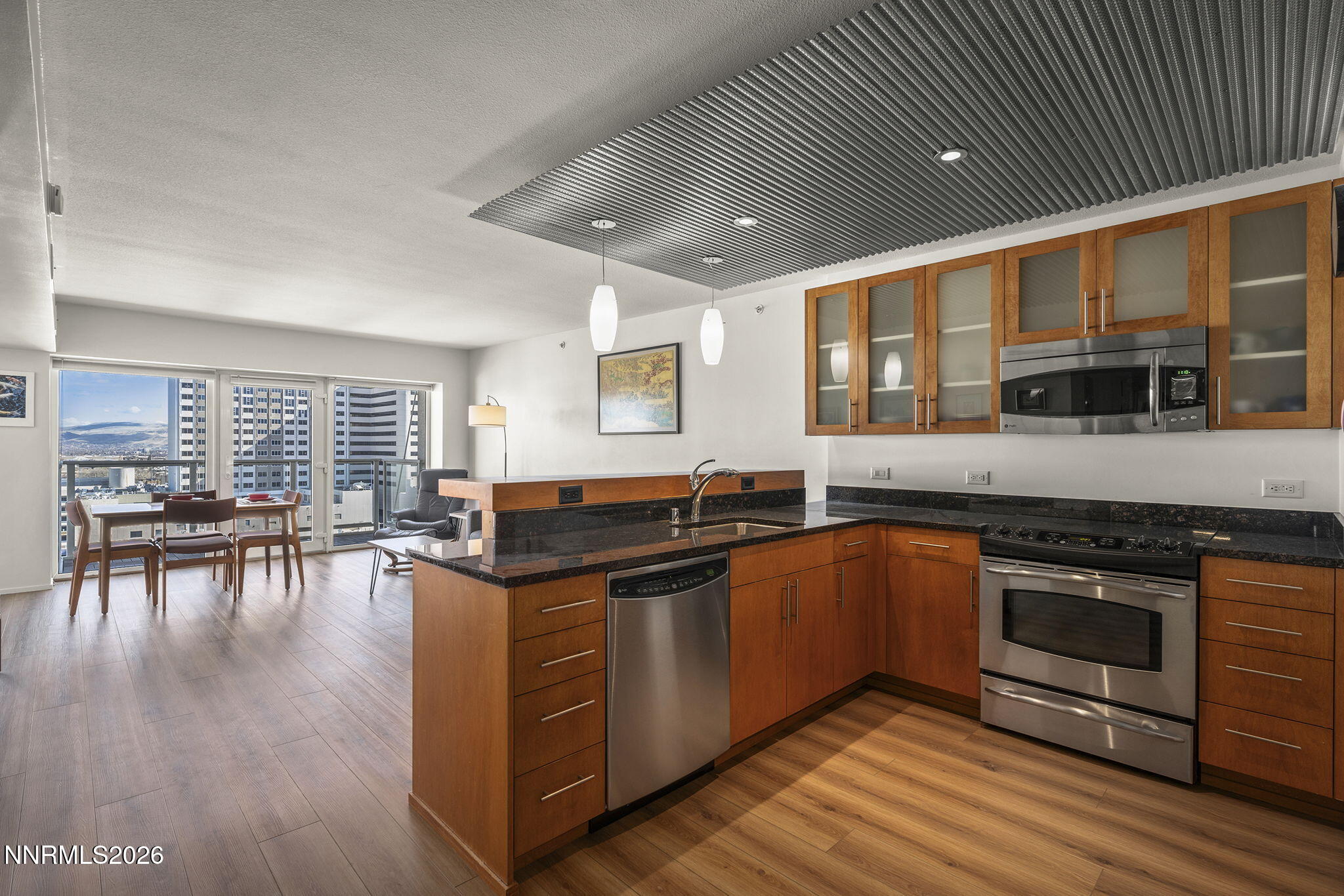 255 North Sierra Street, Unit 1408 Reno, NV 89501 - Photo 2 of 40 a kitchen with stainless steel appliances granite countertop a stove and a wooden cabinets