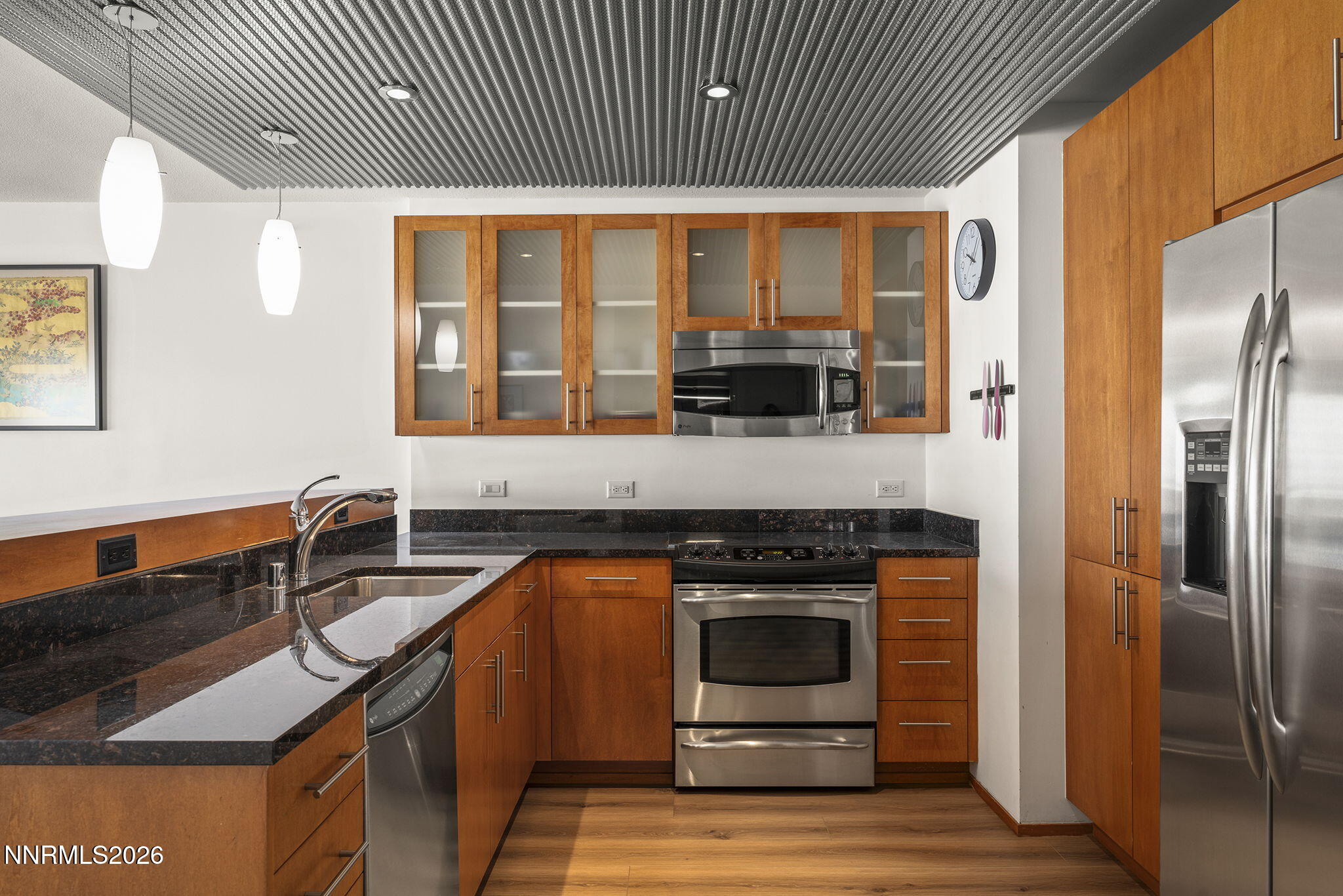 255 North Sierra Street, Unit 1408 Reno, NV 89501 - Photo 3 of 40 a kitchen with stainless steel appliances granite countertop a stove a sink and a refrigerator