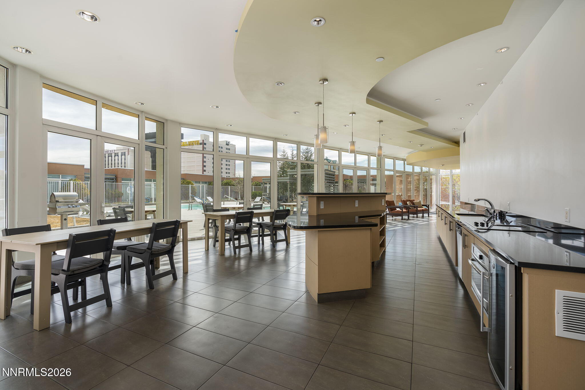 255 North Sierra Street, Unit 1408 Reno, NV 89501 - Photo 31 of 40 a dining hall with stainless steel appliances a dining table and chairs
