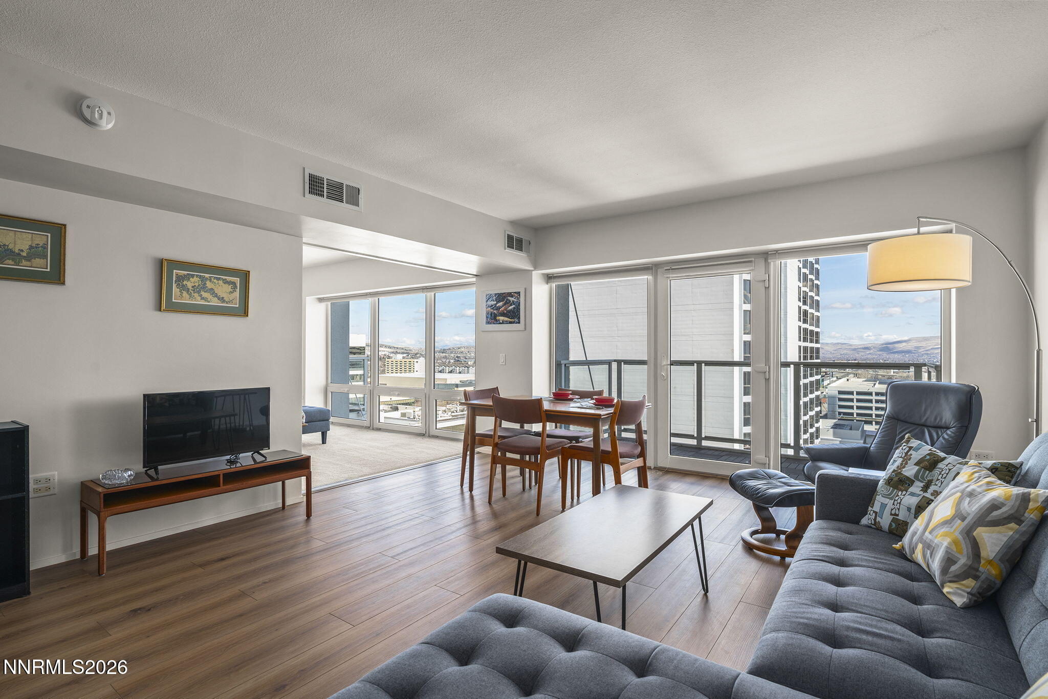 255 North Sierra Street, Unit 1408 Reno, NV 89501 - Photo 4 of 40 a living room with furniture a flat screen tv and a large window