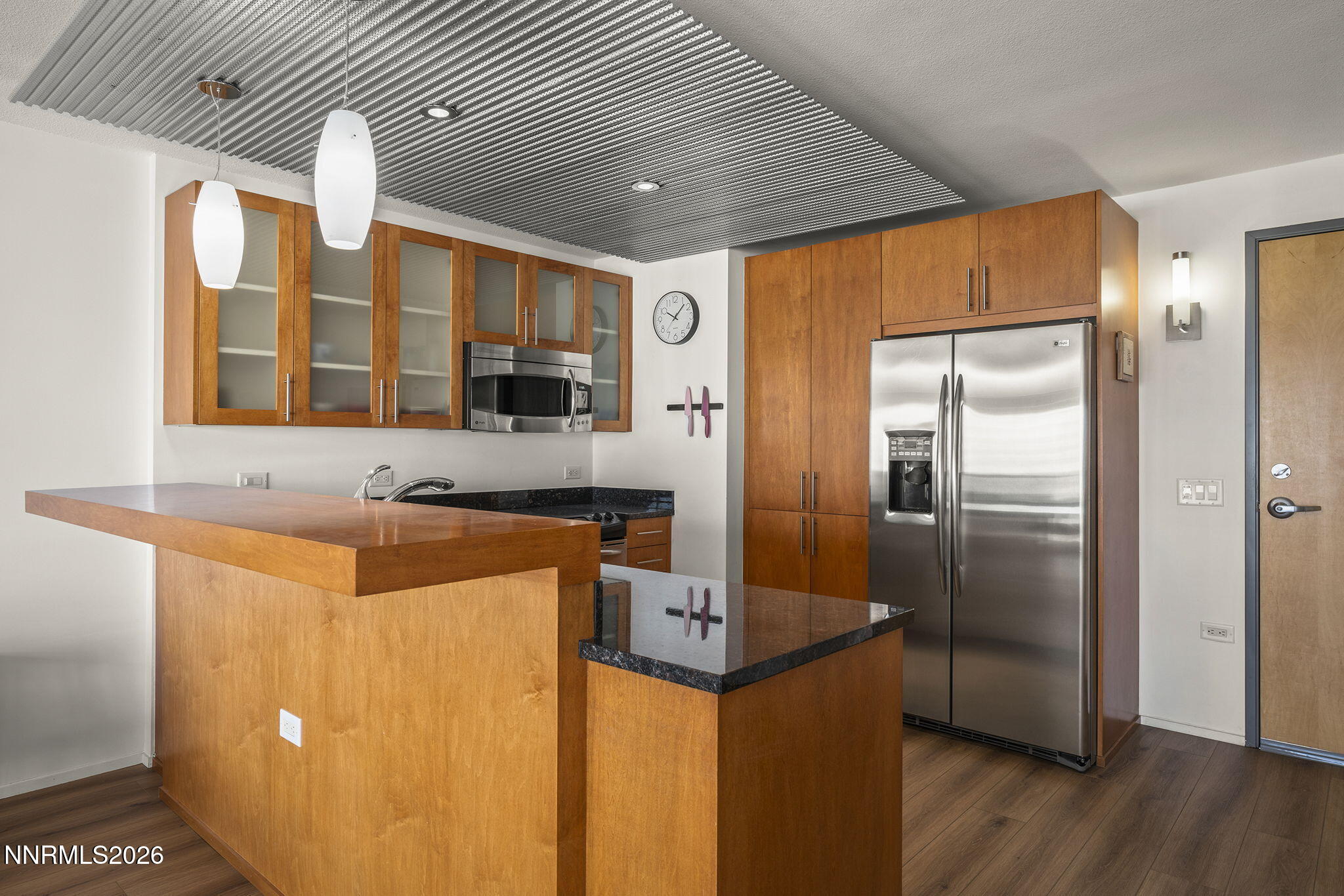 255 North Sierra Street, Unit 1408 Reno, NV 89501 - Photo 5 of 40 a kitchen with stainless steel appliances granite countertop a refrigerator and a stove