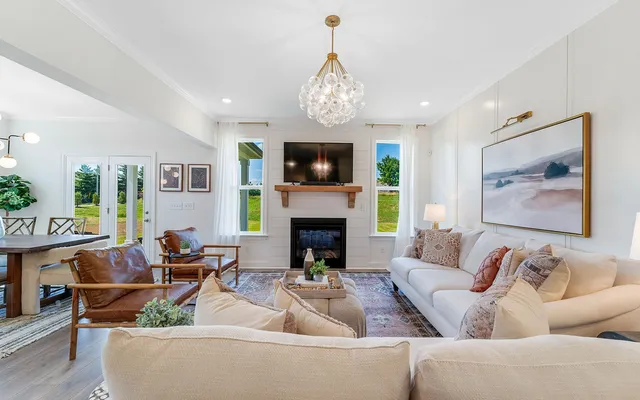 a living room with furniture a fireplace and a flat screen tv