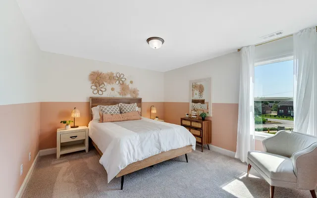 a bedroom with a bed and window