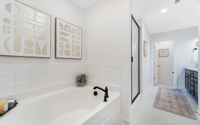 a bathroom with a bathtub and a shower