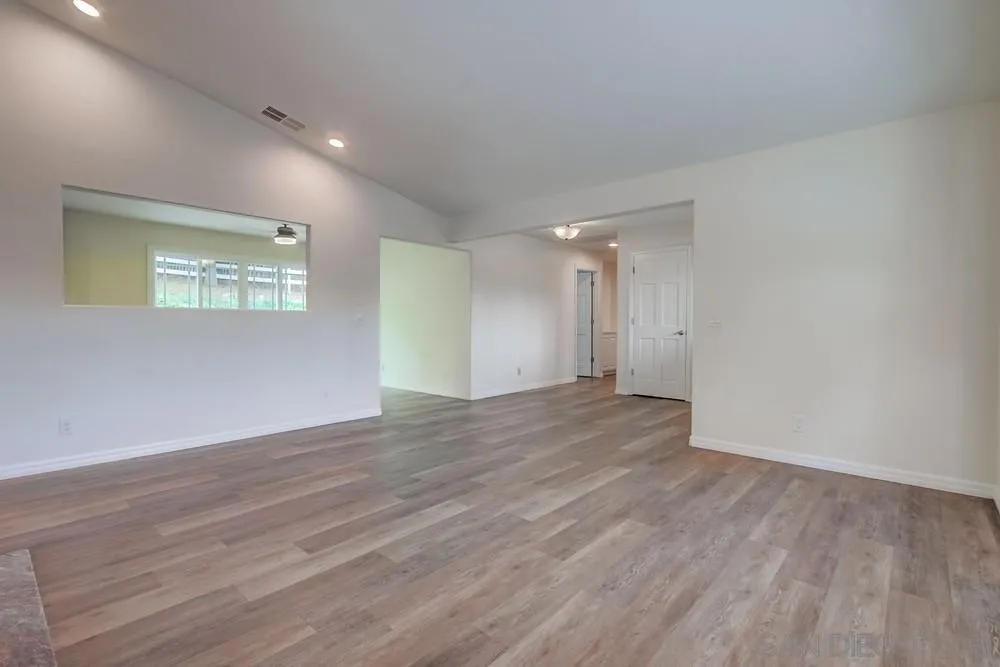 227 Hutchison Street Vista, CA 92084 - Photo 13 of 58 a view of an empty room with wooden floor and closet