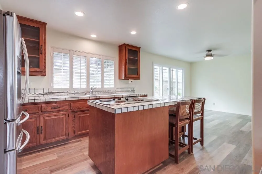 227 Hutchison Street Vista, CA 92084 - Photo 18 of 58 a kitchen with stainless steel appliances granite countertop a stove a sink and a refrigerator