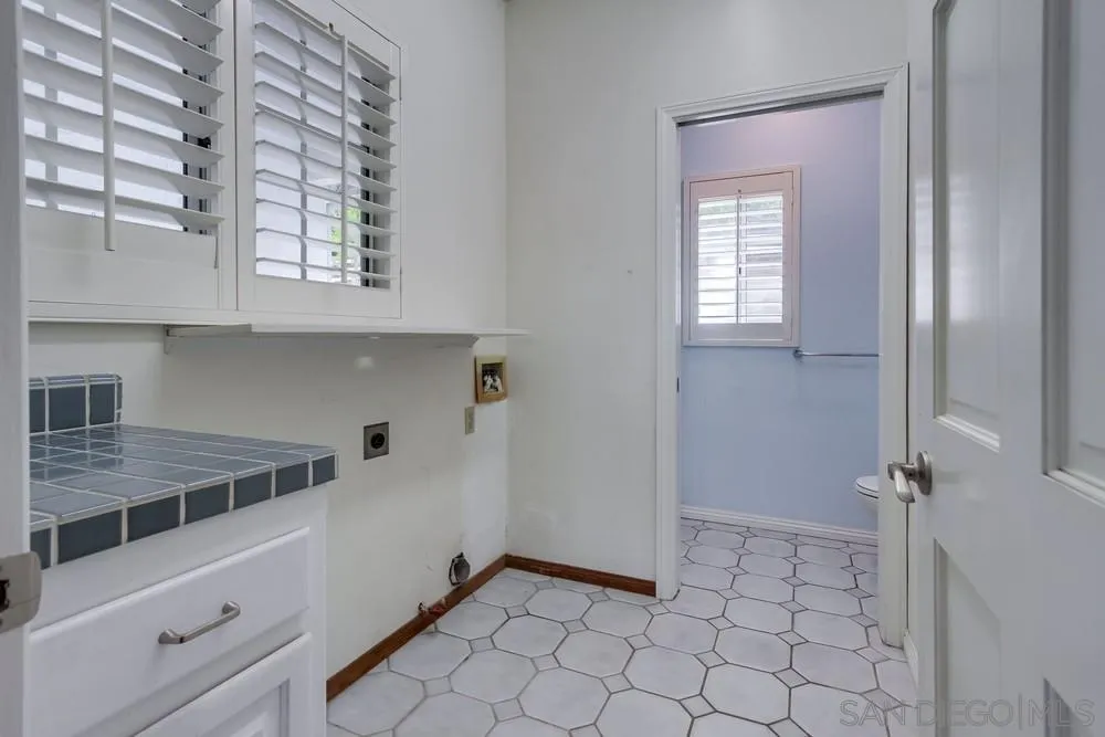 227 Hutchison Street Vista, CA 92084 - Photo 23 of 58 a kitchen with a sink cabinets and utility