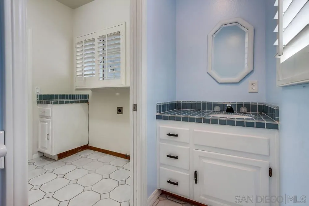 227 Hutchison Street Vista, CA 92084 - Photo 24 of 58 a bathroom with a sink and a mirror