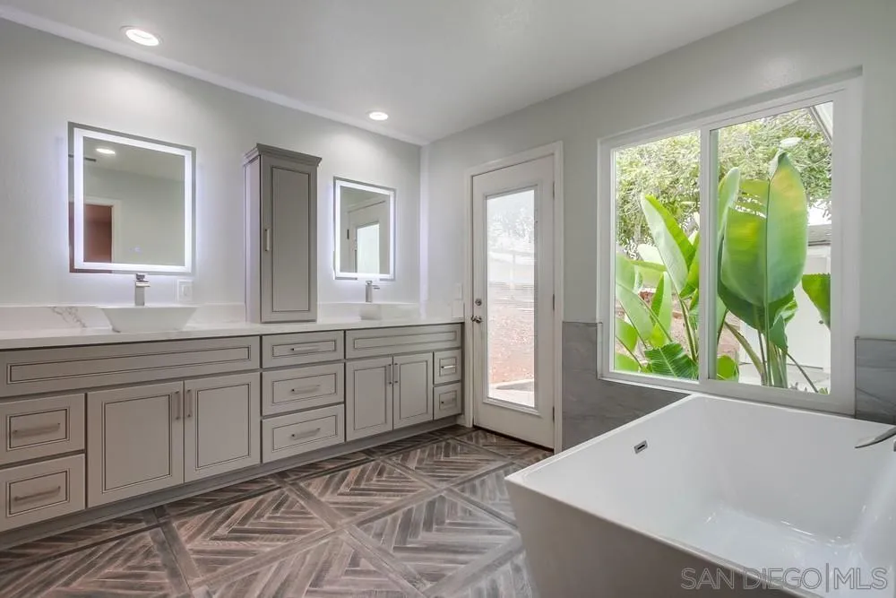 227 Hutchison Street Vista, CA 92084 - Photo 34 of 58 a spacious bathroom with a tub sink and mirror