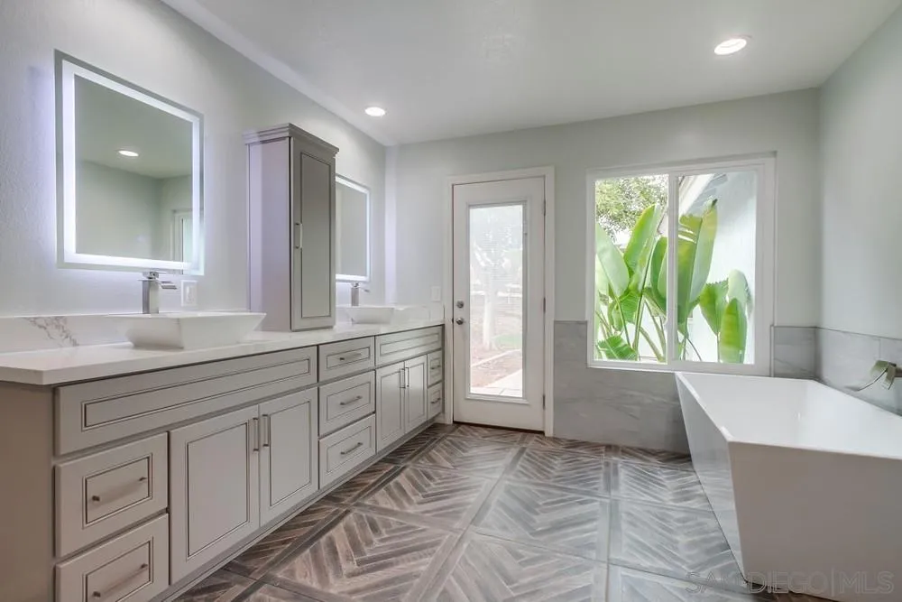 227 Hutchison Street Vista, CA 92084 - Photo 35 of 58 a spacious bathroom with a tub sink and mirror