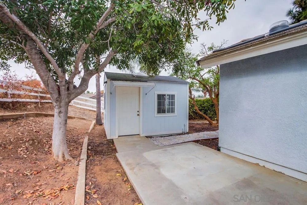 227 Hutchison Street Vista, CA 92084 - Photo 41 of 58 a view of a house with a tree in the background