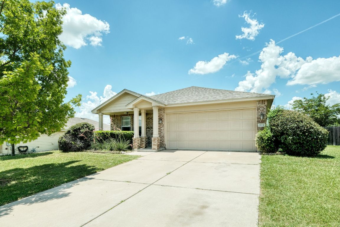 a front view of house with yard and green space