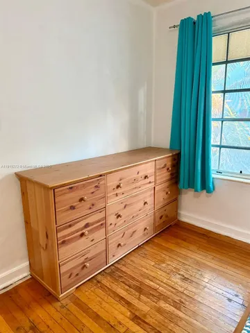 a view of wooden floor and windows in a room