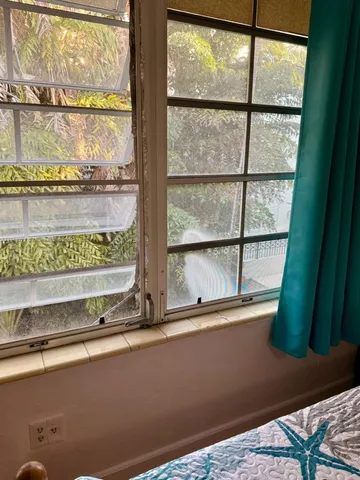 a room with a large window and a bed