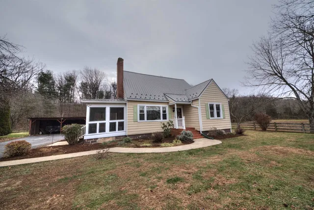 a front view of a house with yard patio and fire pit