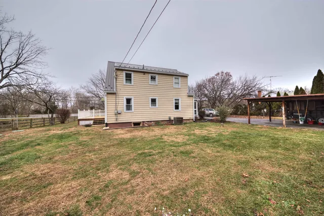 a living room with furniture a chandelier and a flat screen tv