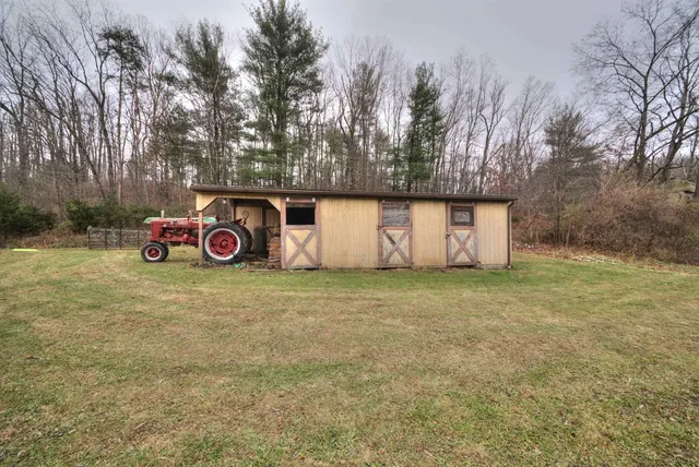 a room with wooden floor and book shelf