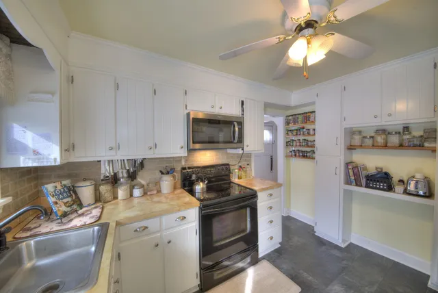 a view of a house with a yard covered in snow