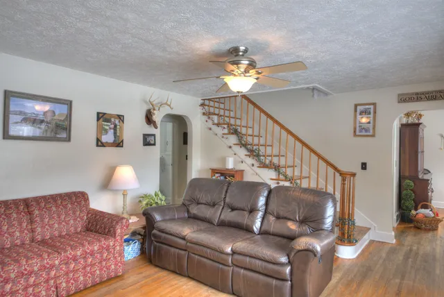 a view of a dining room with furniture a chandelier and wooden floor