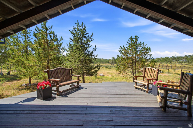 1663 Lancer Lane Evanston, UT 82930 - Photo 91 of 101 Expansive covered deck featuring wood-finish decking and exposed wood beams