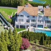 a aerial view of a house with a yard table and chairs