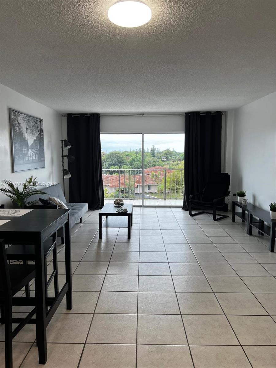 4164 Inverrary Drive, Unit 510 Lauderhill, FL 33319 - Photo 1 of 21 a living room with furniture and a large window