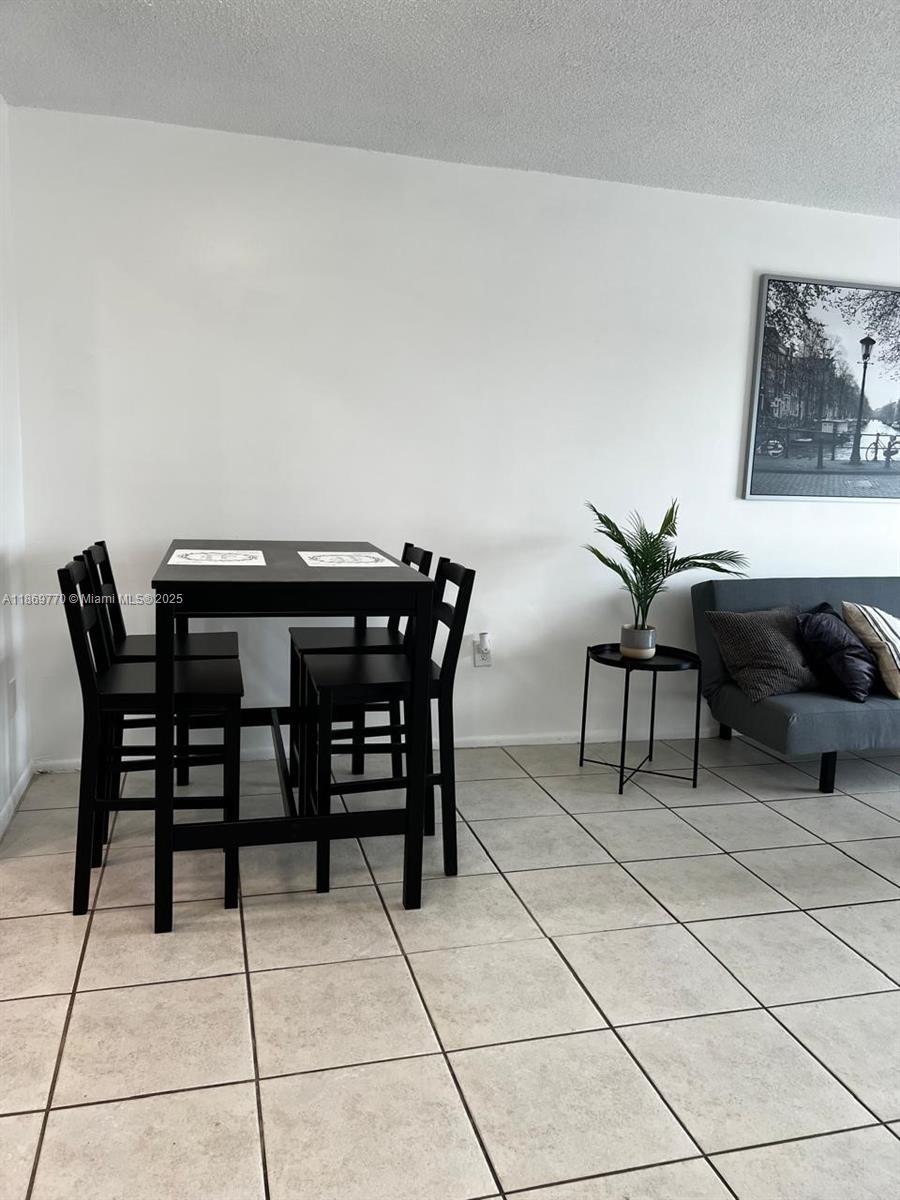 4164 Inverrary Drive, Unit 510 Lauderhill, FL 33319 - Photo 11 of 21 a view of a dining room with furniture and chandelier